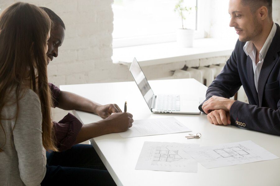 interracial-couple-signing-mortgage-investment-contract-meeting-with-broker Apply Online With HomeEquityLoans.ca